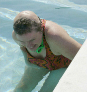 Trying to stand at ledge self; pulling w/ right arm more than using legs still